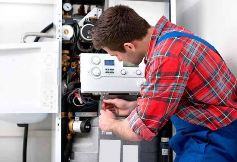 Electrician fixing hot water system which represents the blog "hot water system installers".